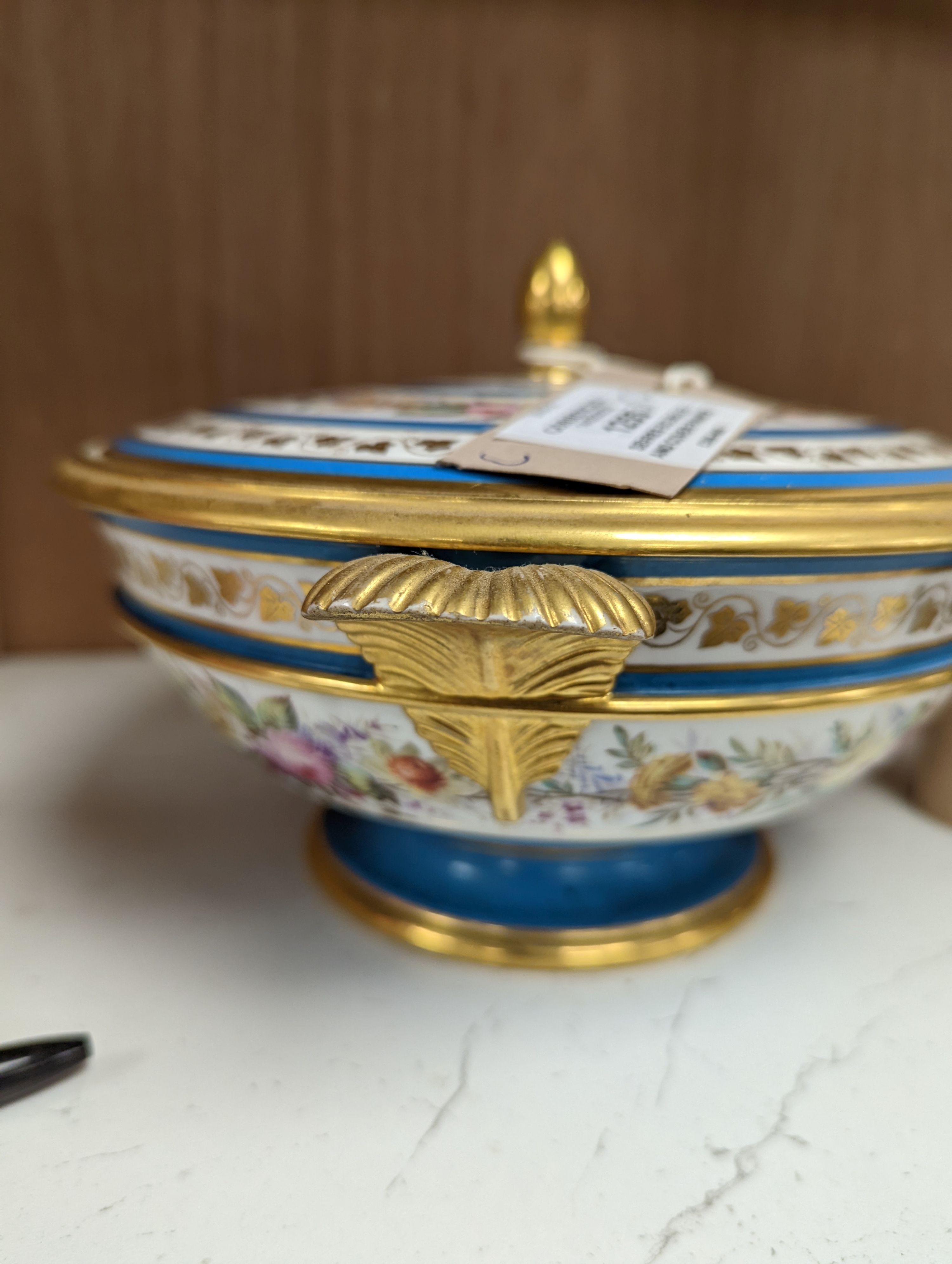 Sevres ecuelle and cover painted with a band of flowers surrounding the gilt monogram of Louis Phillipe, blue mark dated 1850, red mark for Chateau de Compiegne 25cm